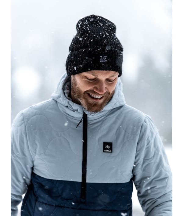 man in snow fall wearing 2117 black knitted cap 1